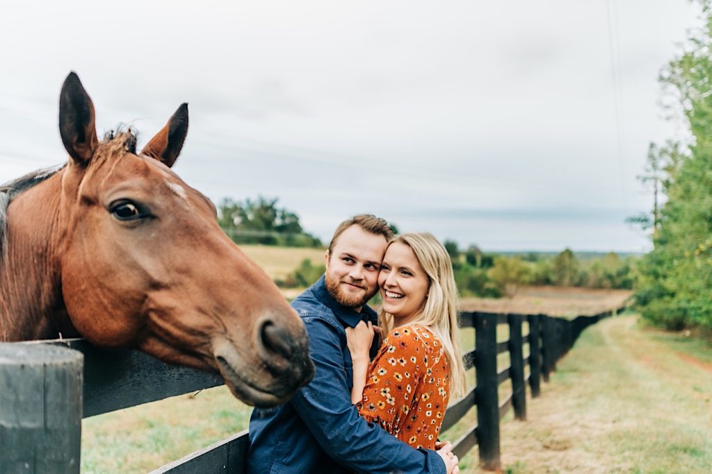 smiling horse next to couple