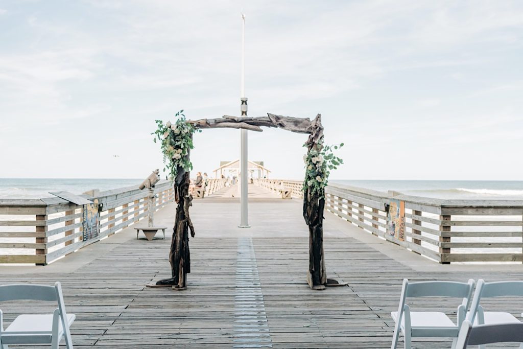 Oyster wedding palette decor at bride and groom first dance at Jennette's Pier