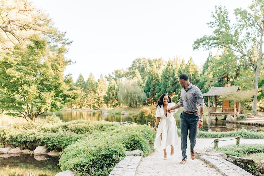 couple walking across bridge in Maymont Japanese Garden