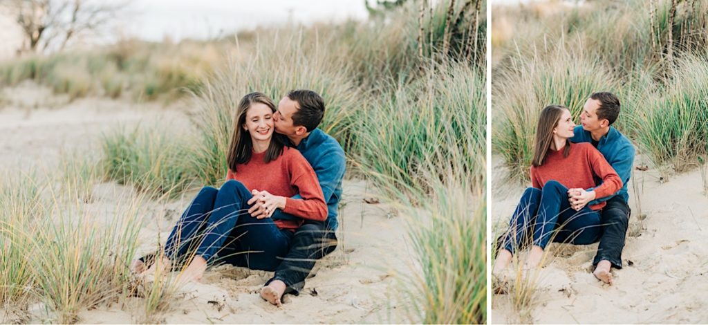 couple snuggling in sand dunes