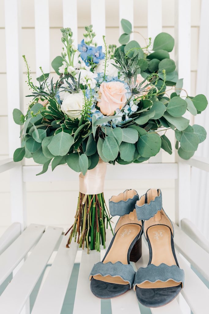 blue and green bouquet with brides blue shoes