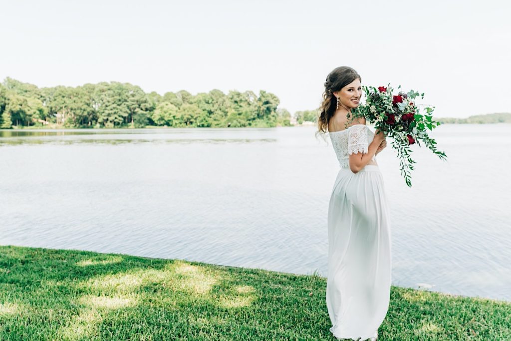 bride next to the water in Virginia with bouquet