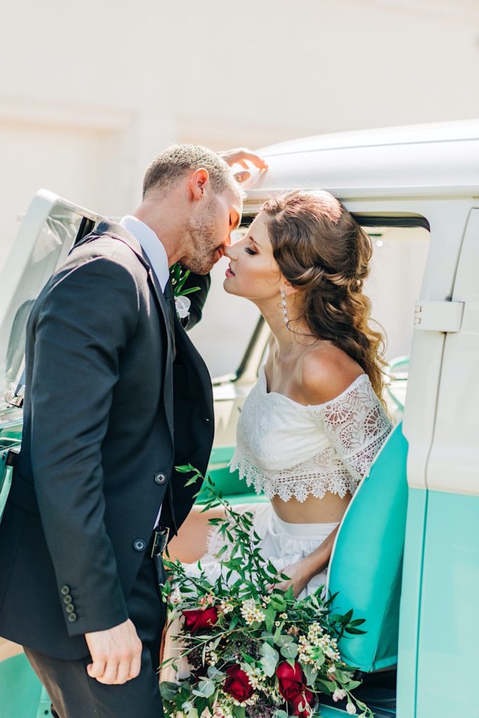 bride and groom getting in a vw bus