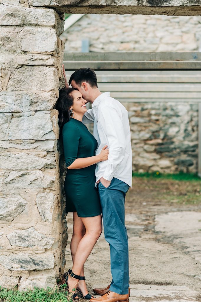 Belle Isle Richmond VA - couple hugging against stone wall