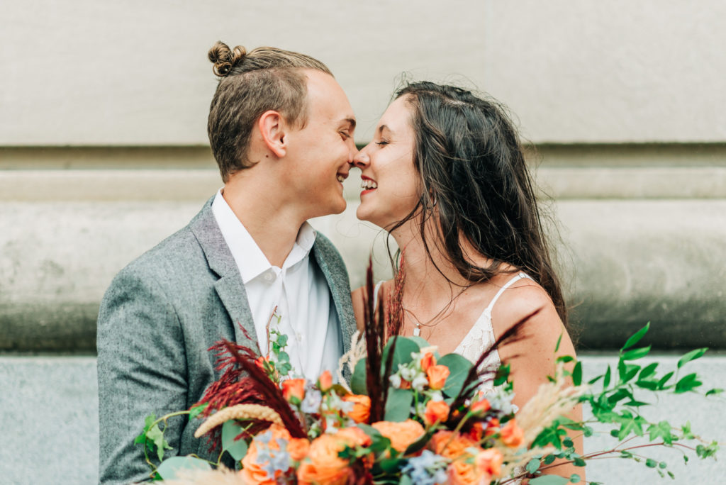How to get married at the Norfolk VA Courthouse, bride and groom eskimo kissing in the rain