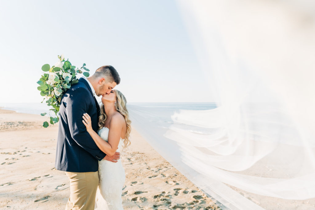 How to get married at the Virginia Beach Courthouse, bride and groom kissing on the beach