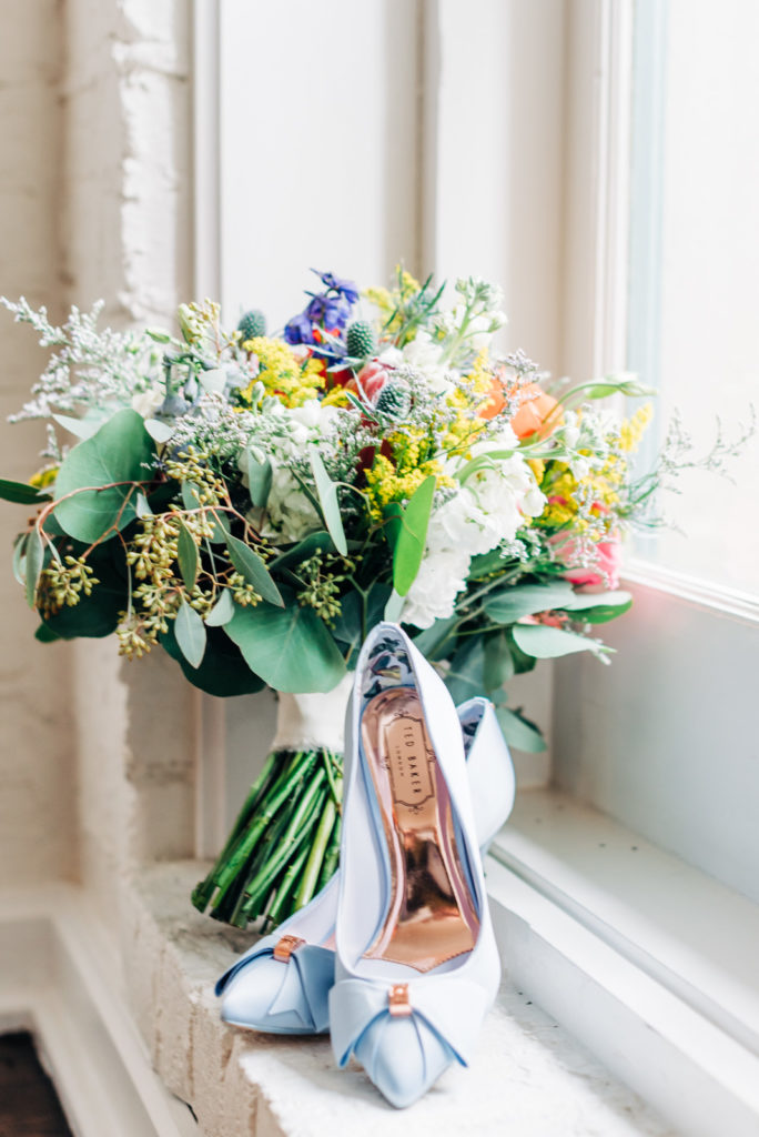 How to get married at the Virginia Beach Courthouse, brides shoes and bouquet waiting at the courthouse