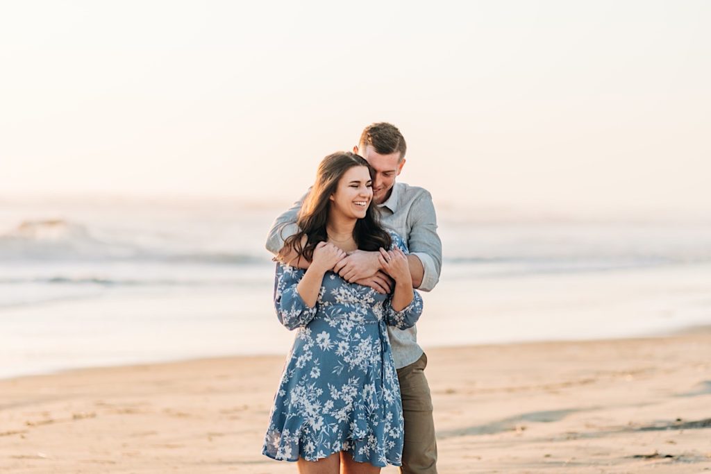 OBX Engagement portraits - Couple hugging on beach