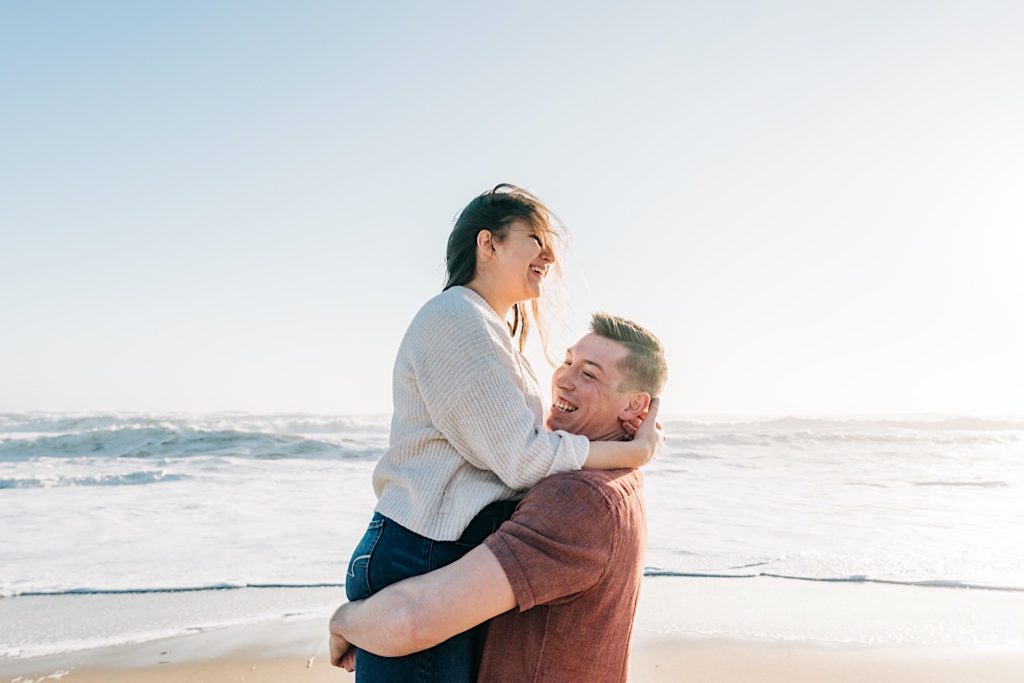 OBX Engagement portraits - guy picking up girl on the beach