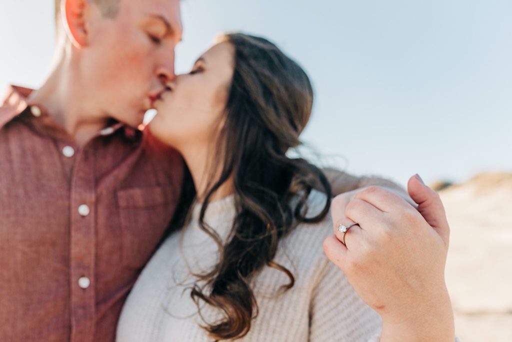 OBX Engagement portraits - a couple kissing ont he beach
