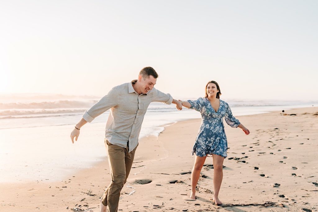 OBX Engagement portraits - couple running on the beach