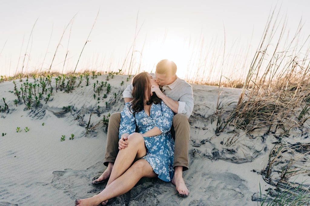 OBX Engagement portraits - couple kissing on a sand dune