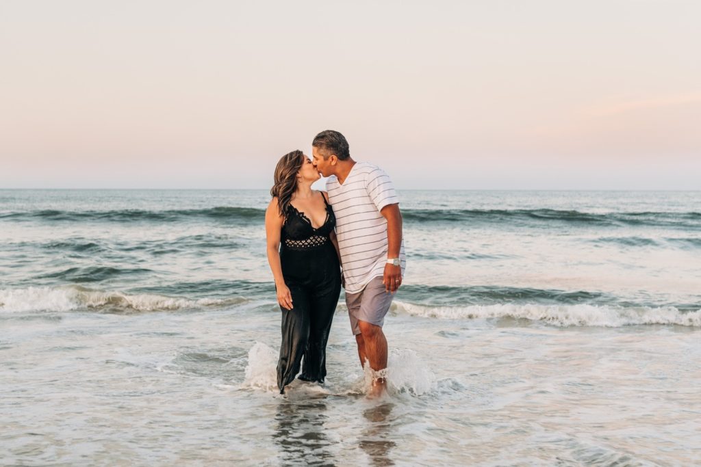 couple kissing in the water at Coquina Beach