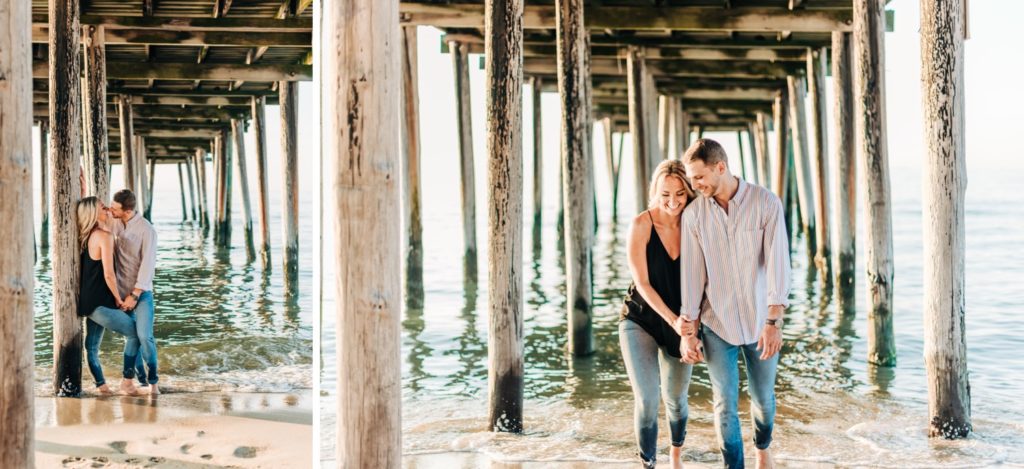 couple walking under pier in Virginia Beach