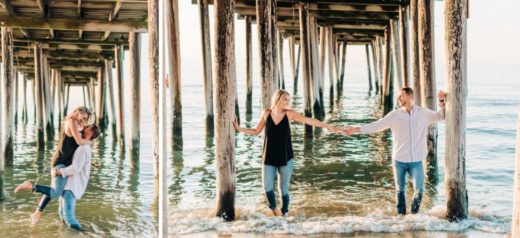 couple standing under pier in Virginia Beach