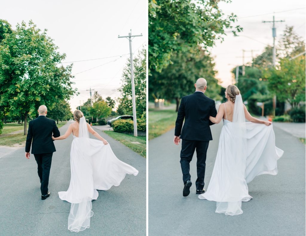 bride and groom walking down the road in Sackets Harbor