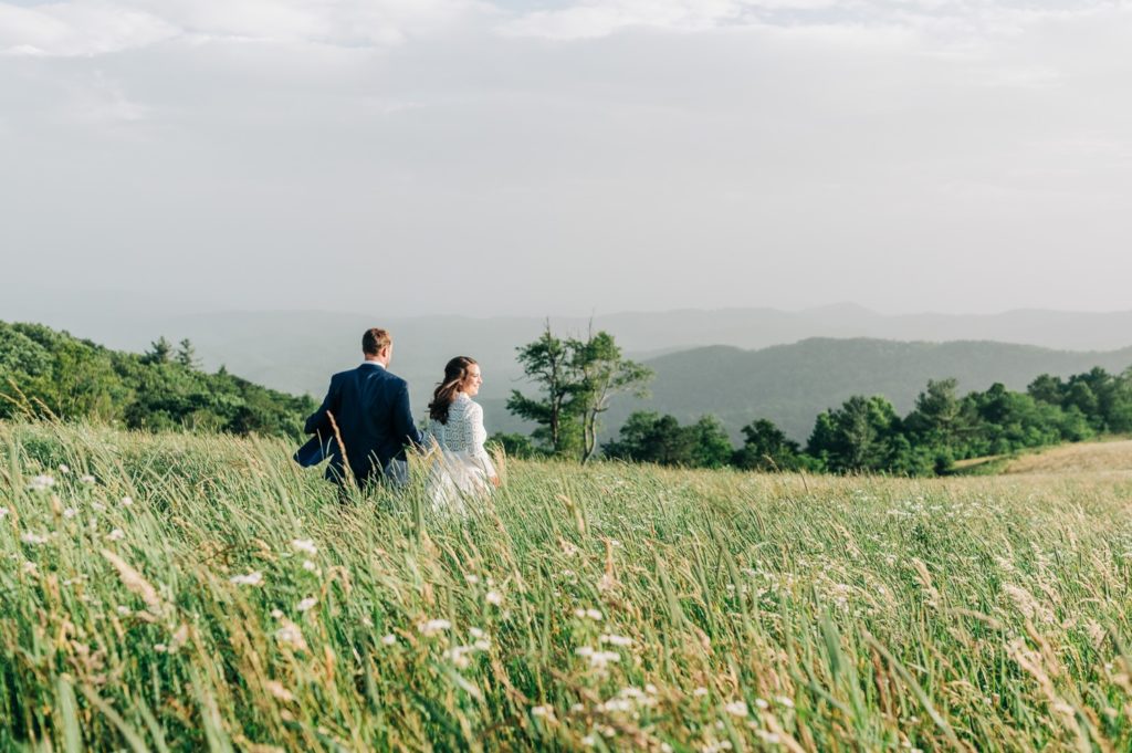 couple running through field after wedding in Boone nc