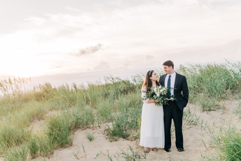 Bride and groom at sunrise beach elopement