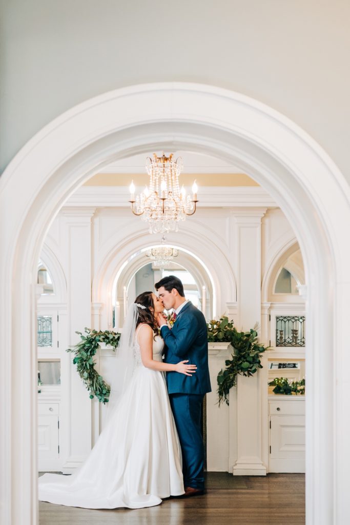 bride and groom kissing at the century club of rochester