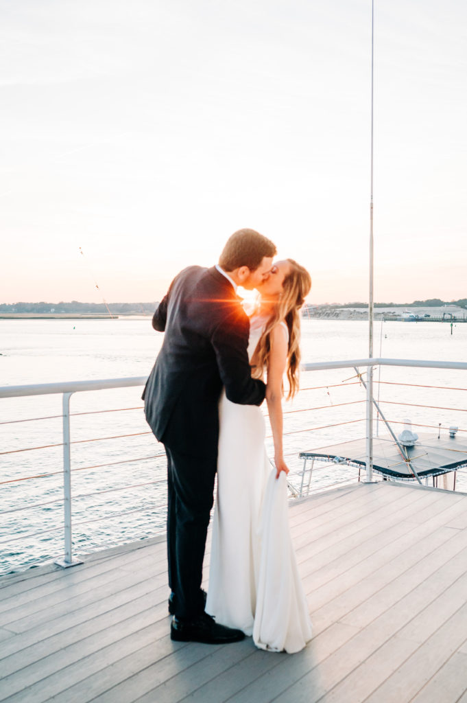 Bride and groom sharing a kiss at sunset and soaking up their wedding day