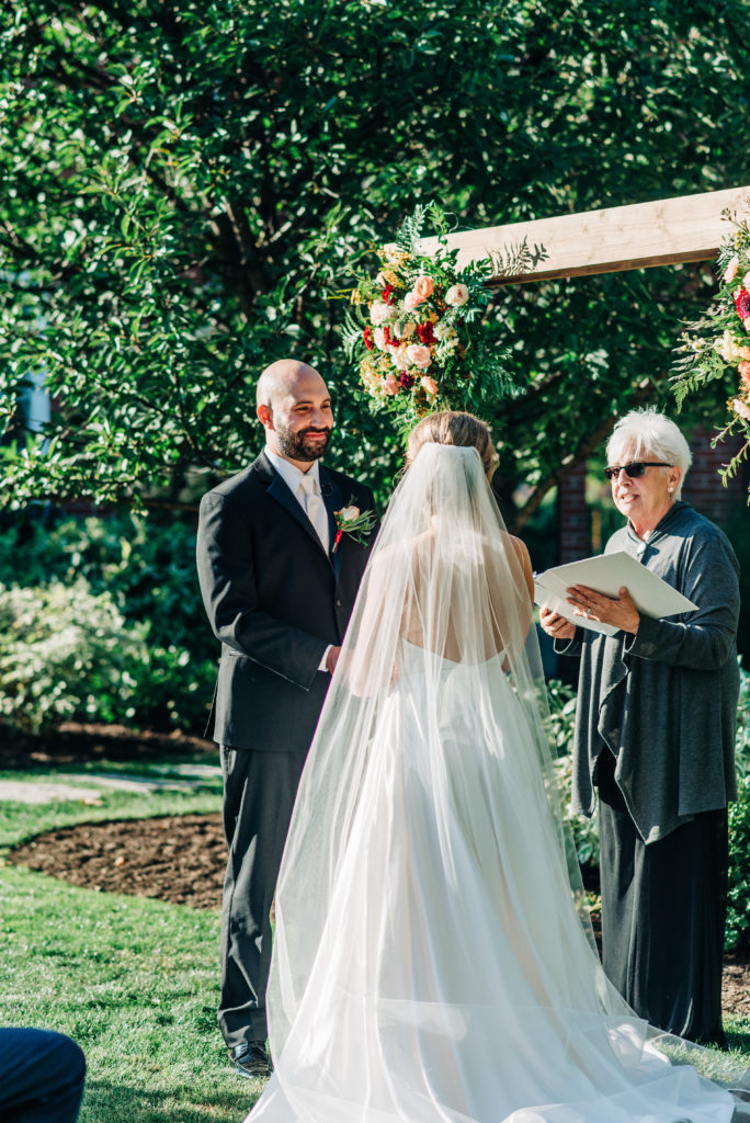 Bride in a veil and groom at altar during ceremony 