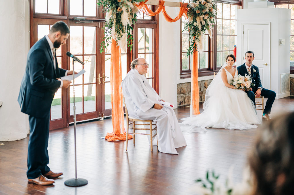 Sibling is speaking to bride and groom during ceremony to help keep the bridal party small