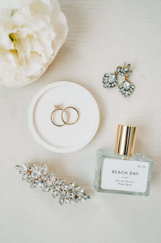 Personalized gifts laid out with brides rings