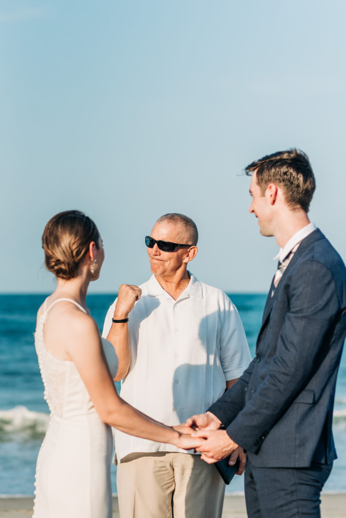 OBX Officiant giving a fist pump during ceremony on the beach
