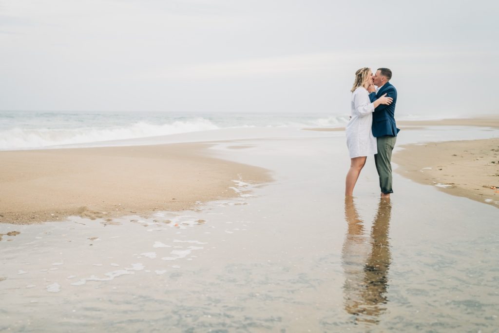 bride and groom embracing on beach