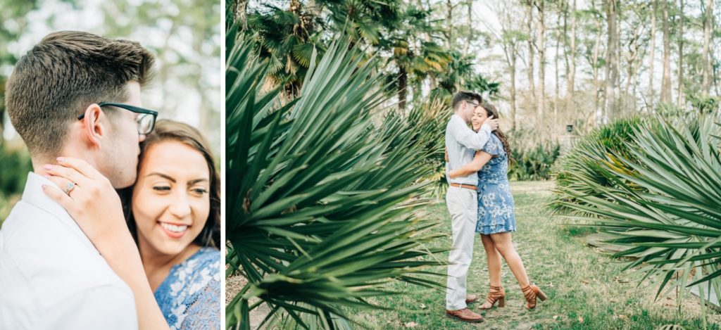 Couple posing among plants at the botanical gardens for engagement photos