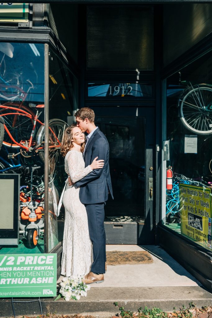 Bride and groom hugging outside of Richmond, VA bike shop