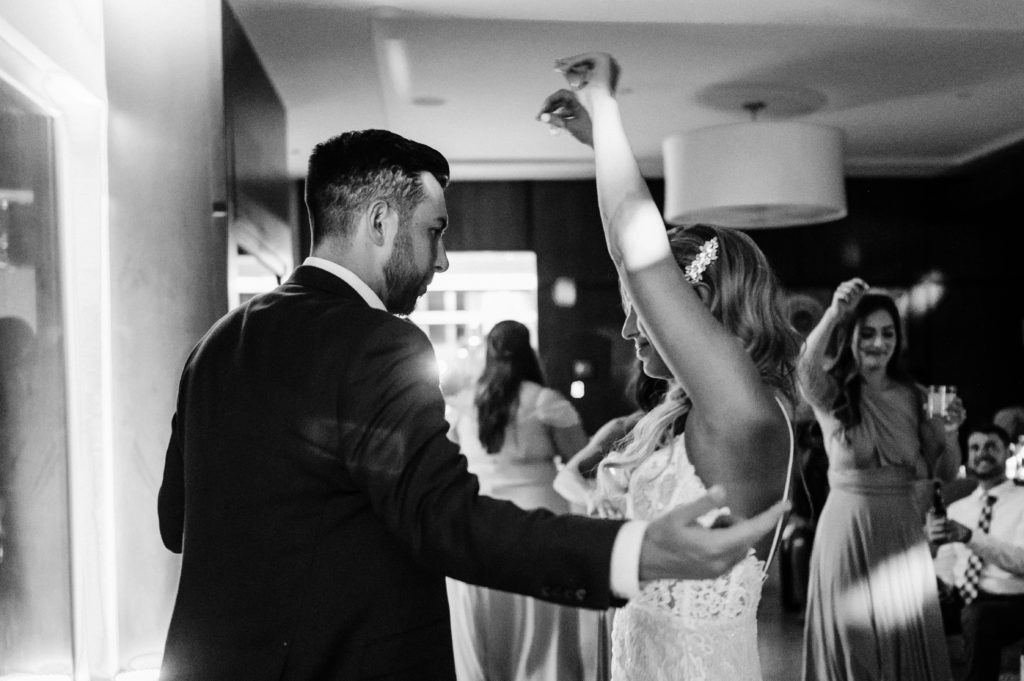 Black and white photo of bride and groom dancing at reception