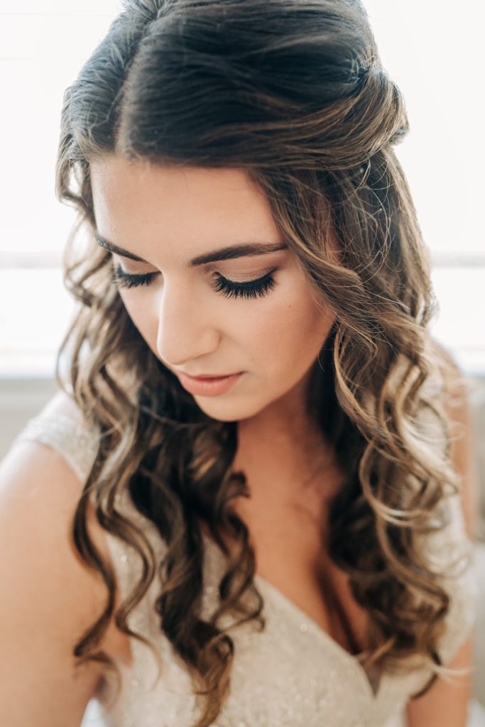 Bride showing off her glam of hair and makeup