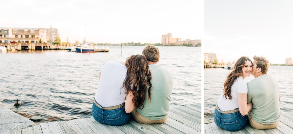 Couple sitting on a dock by the water for their Virginia Beach engagement photos