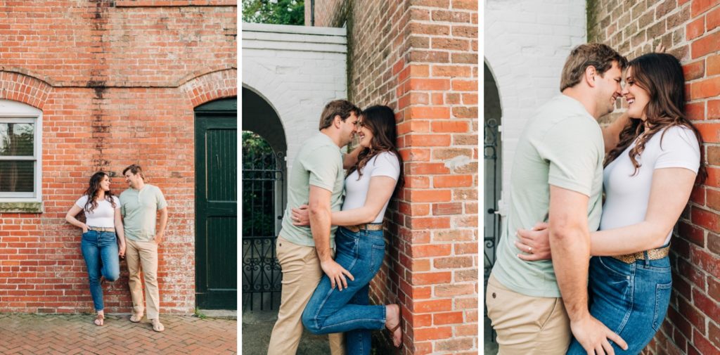 Couple leaning up against brick building embracing.