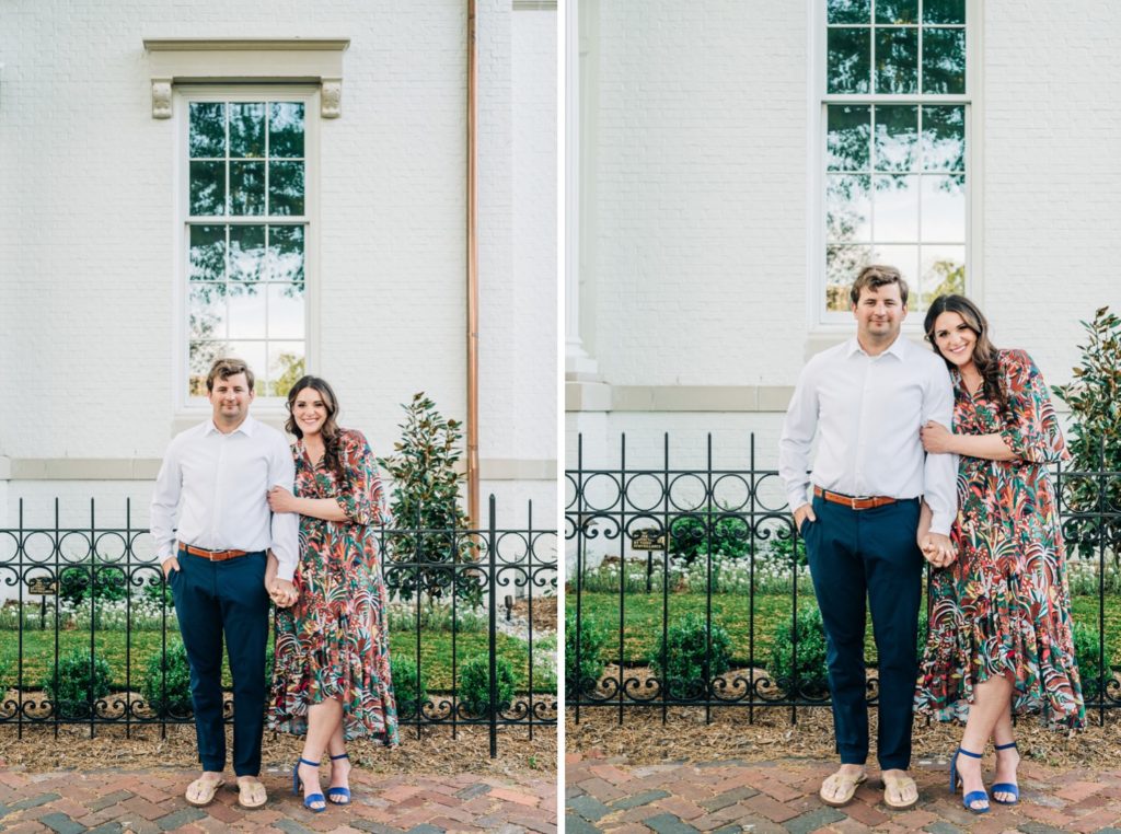 Couple posing in front of a home for their Virginia Beach engagement portraits