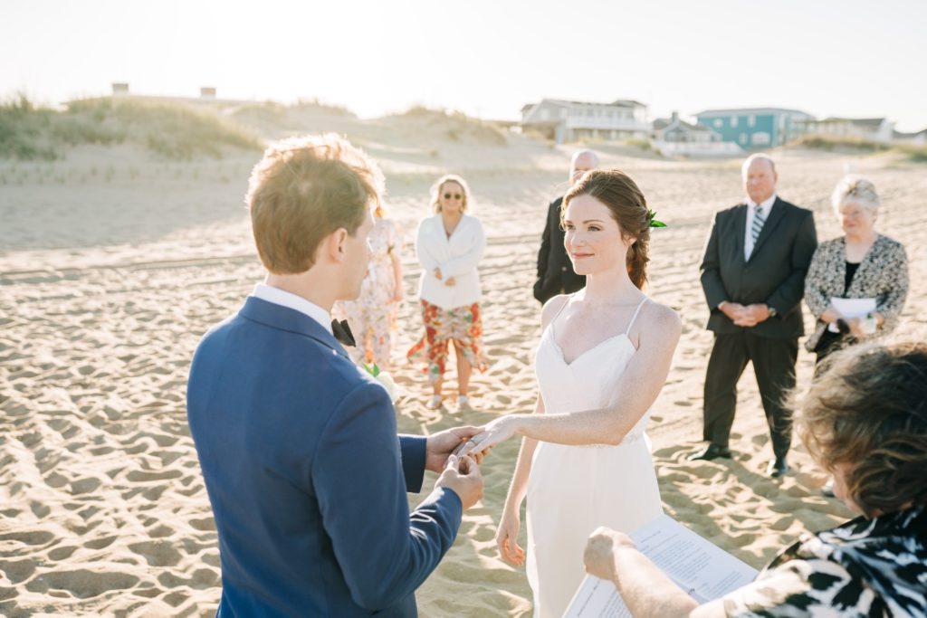 Bride and groom holding hands during wedding ceremony in Virginia Beach