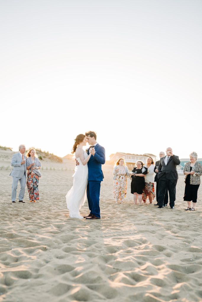 Bride and groom dancing on the beach after their elopement