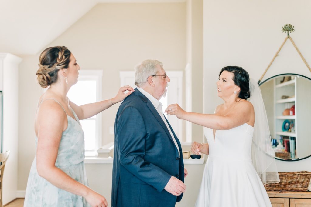 Bride and bridesmaid with the father of the bride before wedding ceremony in Corolla NC