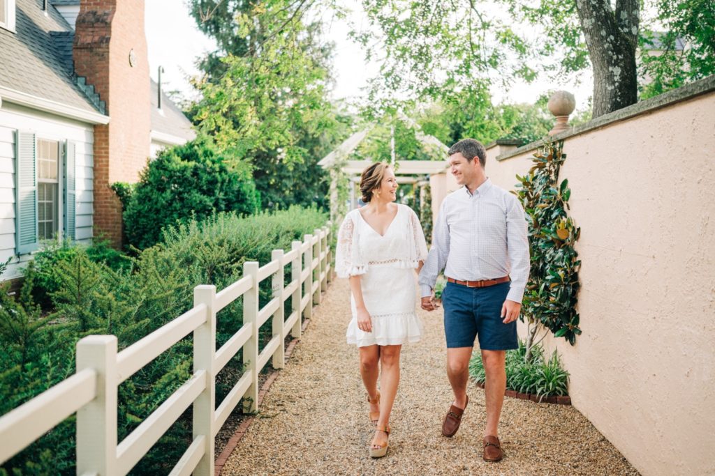 Couple walks hand in hand during engagement photos session
