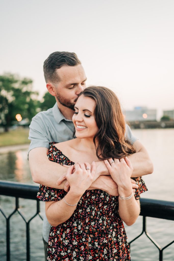 Couple embracing on bridge in the Free Mason district for engagement photos