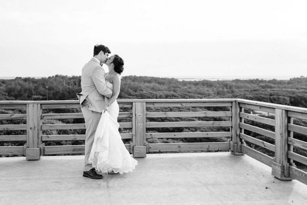 Bride and groom embracing after Pine Island lodge wedding in Duck NC