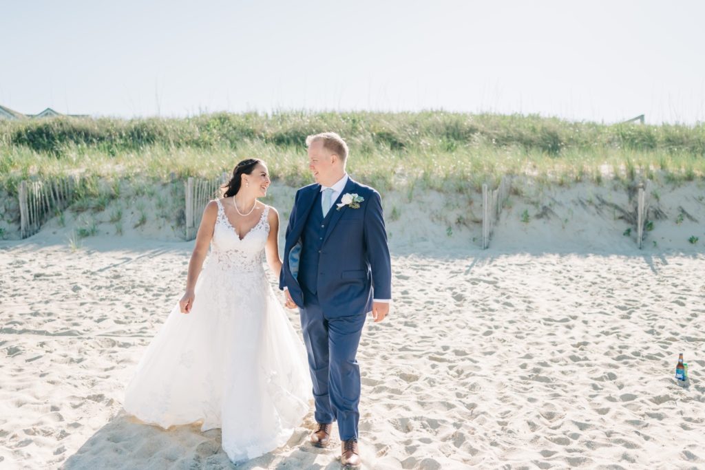 Couple walking along beach after wedding at Sanderling Resort in Duck, NC