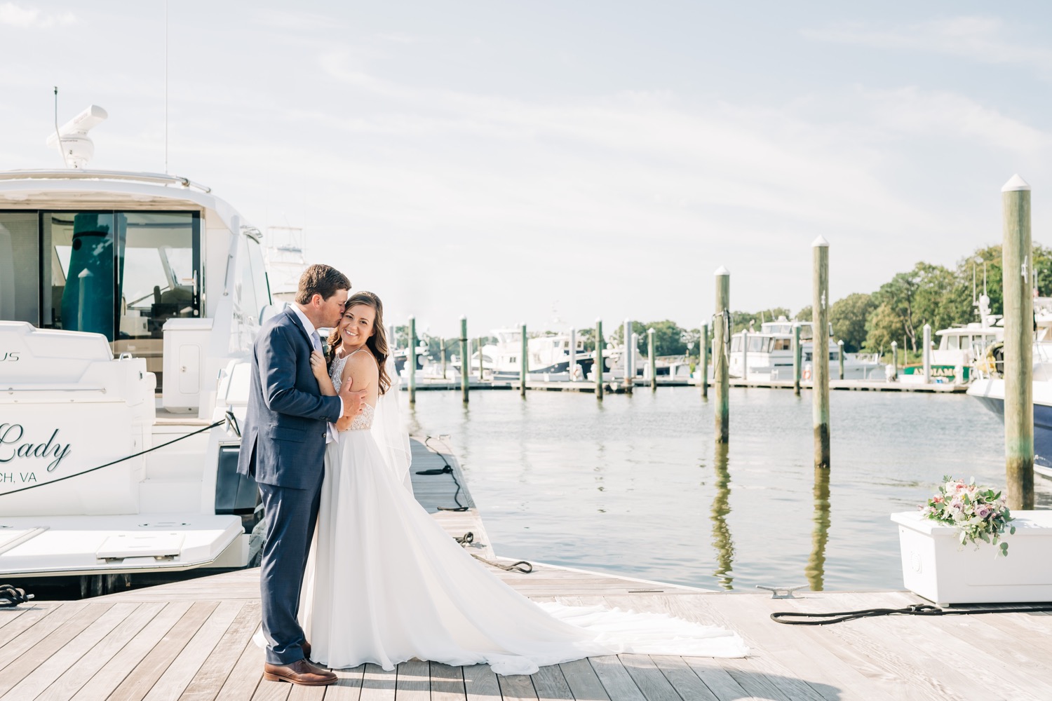 Bride and groom hugging on Marina at the Cavalier Golf and Yacht Club