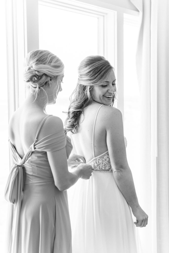 bride and maid of honor getting ready