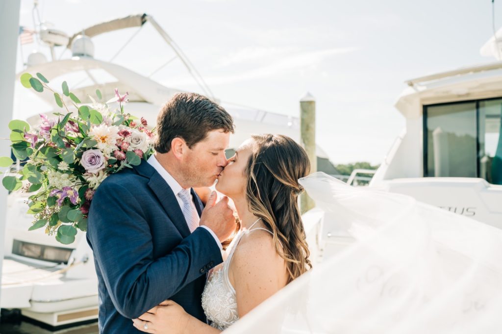 Bride and groom kissing with veil at Cavalier Golf and Yacht Club