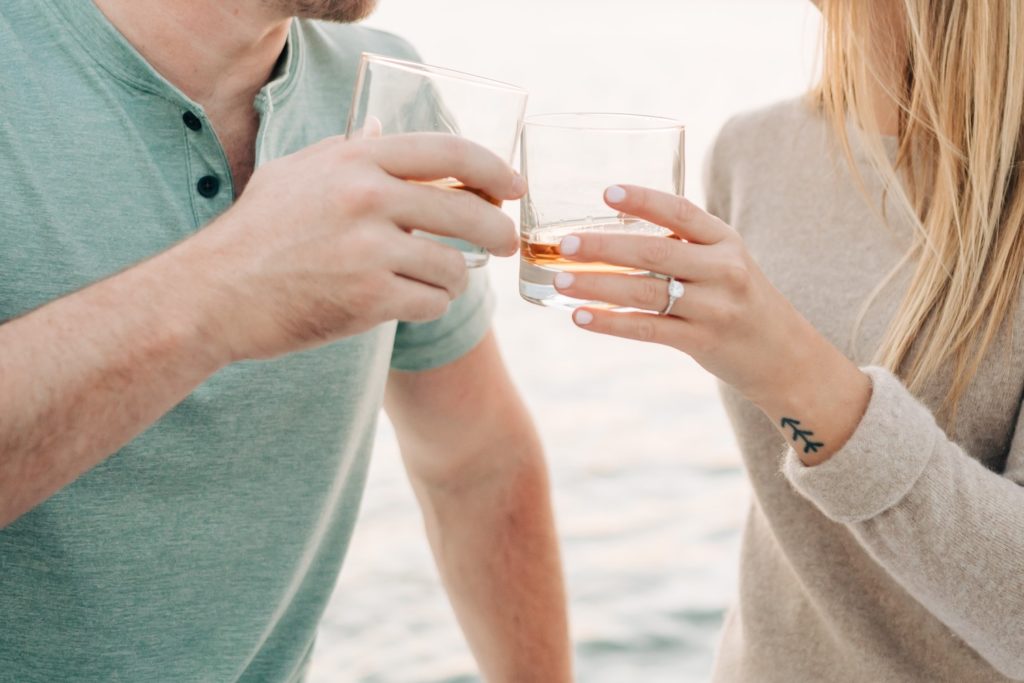 couple sharing bourbon on sunset boat ride on lake Anna