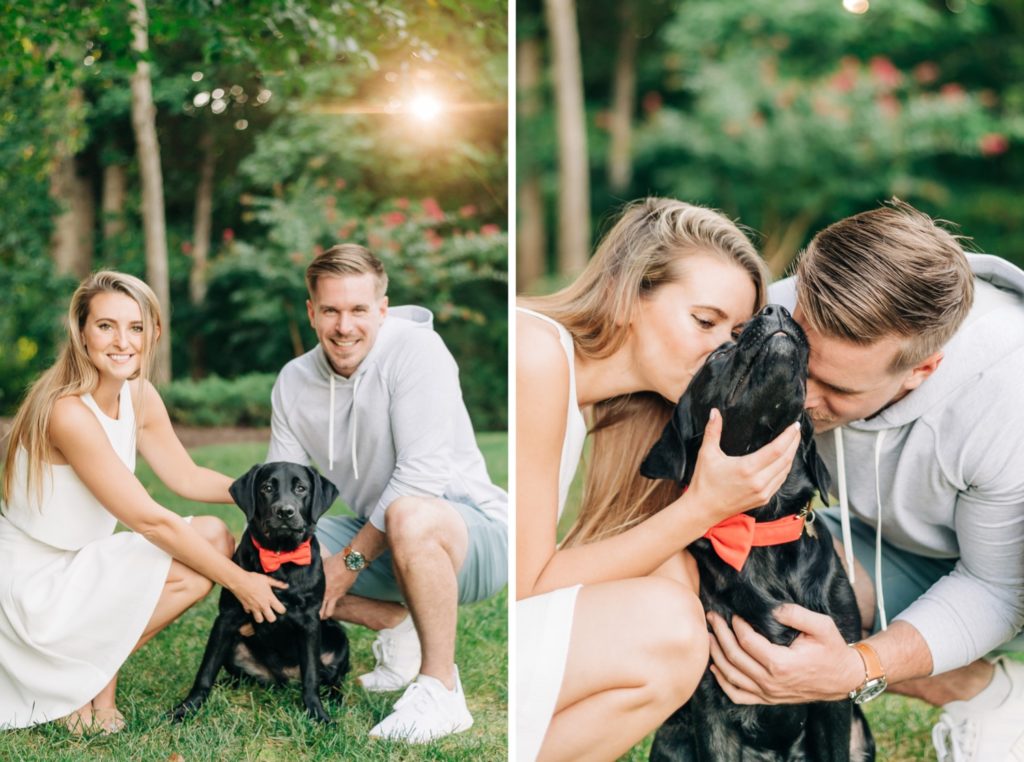 couple posing with their black lab puppy on lake Anna