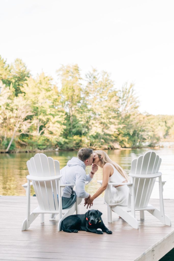 couple kissing while sitting on the dock on lake Anna