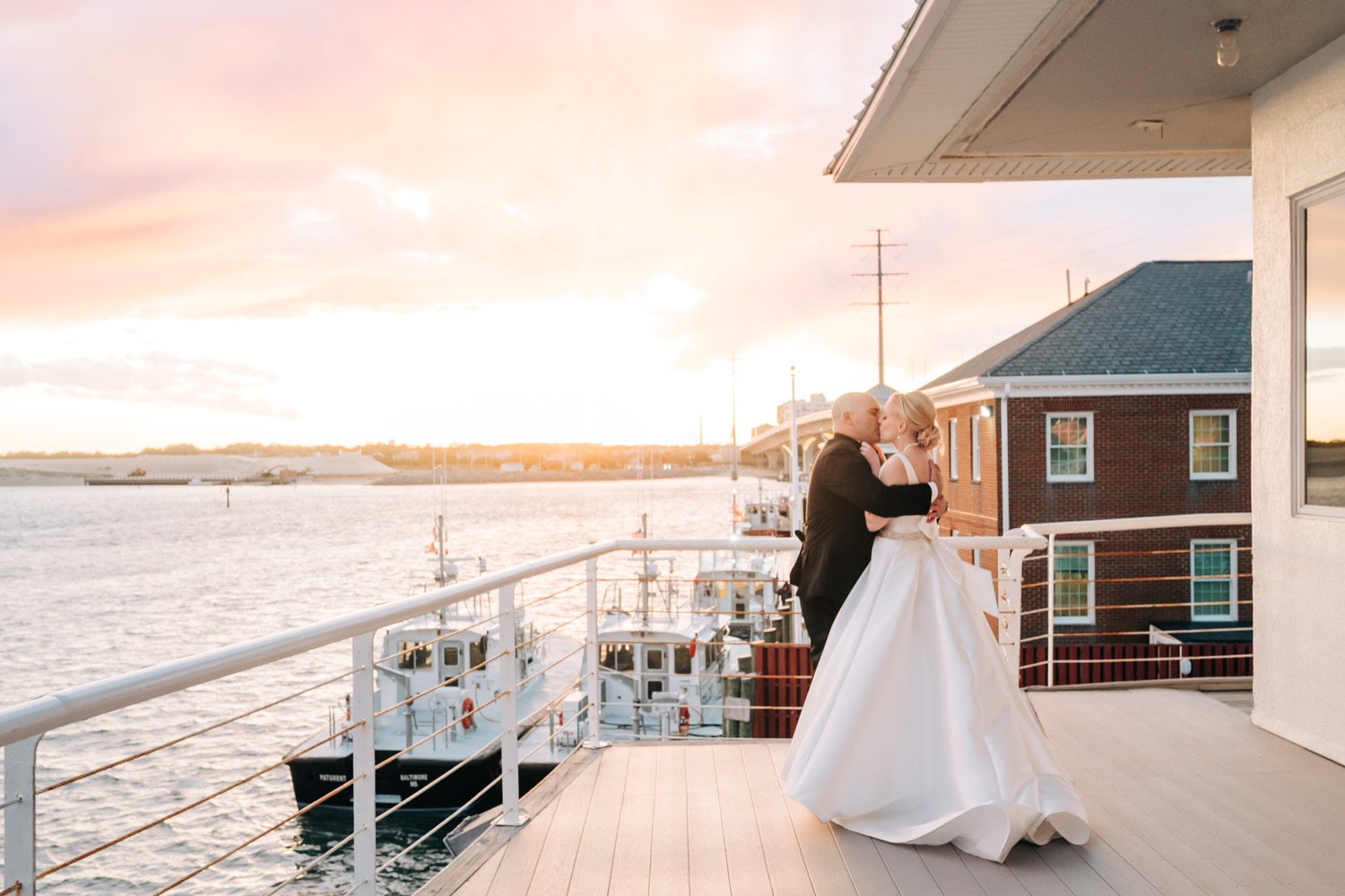Bride and groom kissing at sunset at Lesner Inn Wedding